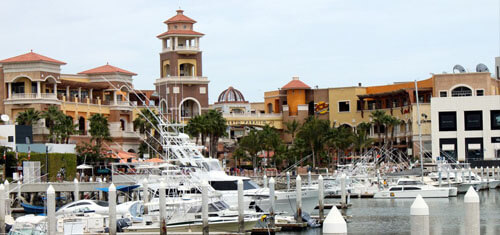Picture of a beautiful marina in Cabo San Lucas, Mexico.  The picture shows several fishing boats in the harbor.